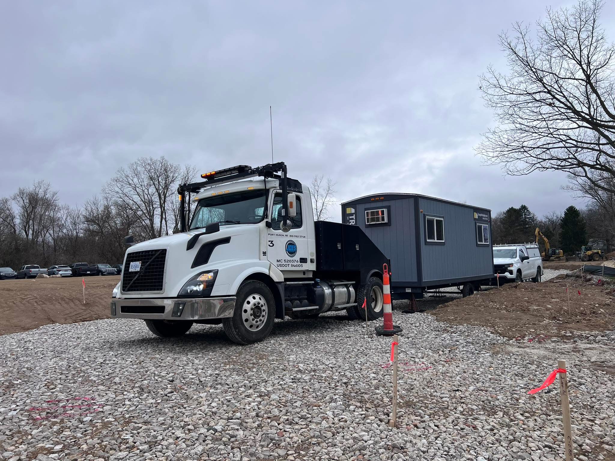 Joe’s Transporting truck 3 with a mobile office at a jobsite
